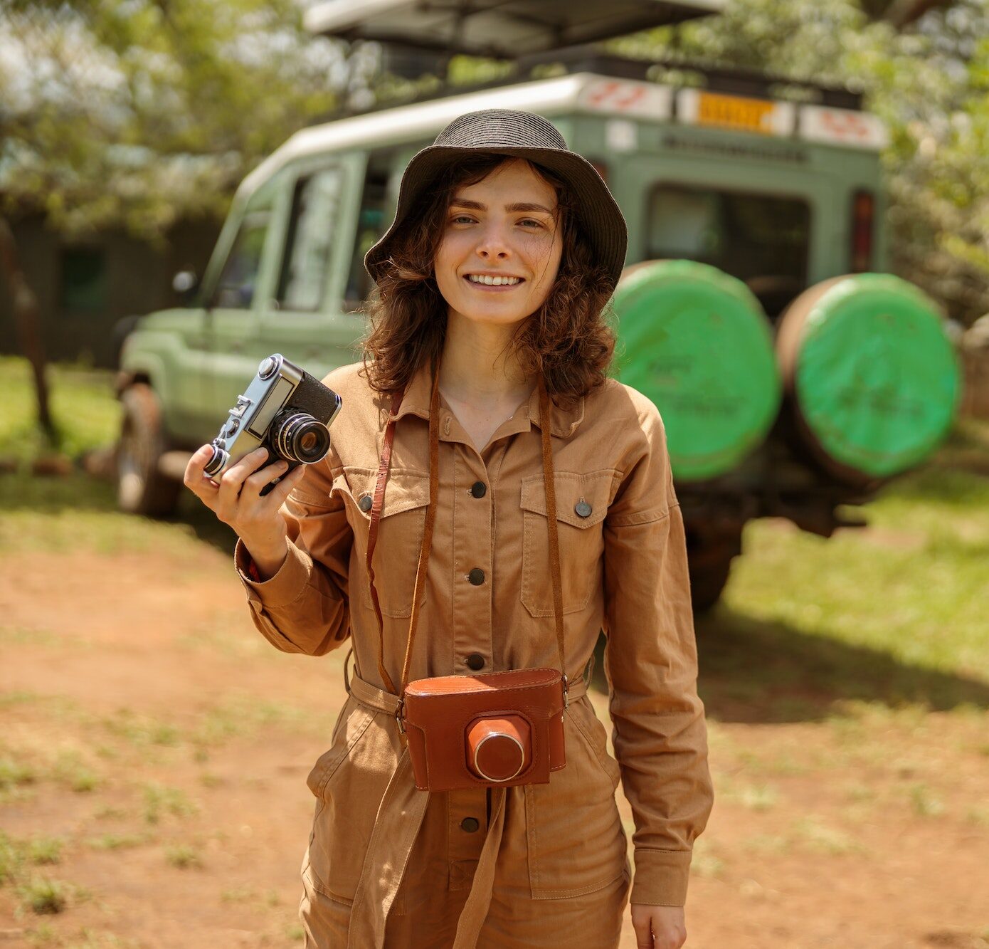Happy woman on safari using photo camera